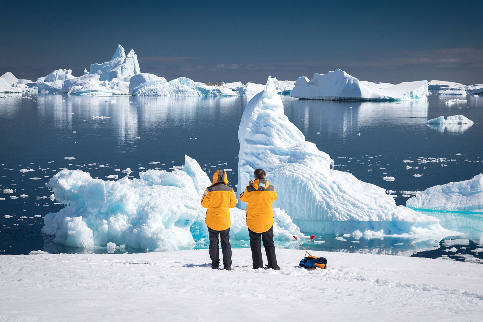 Quark Expeditions guests photograph ice formations at Port Charcot Bay, Antarctica.