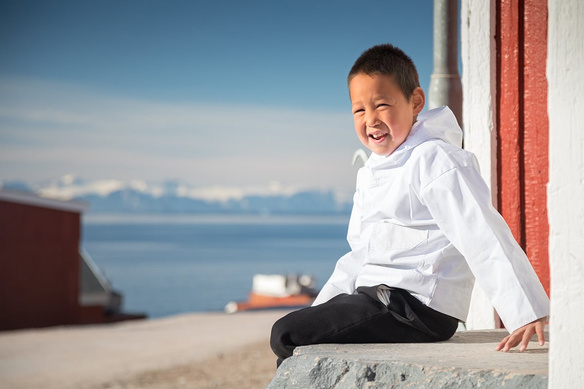 A young Greenlandic boy models the Greenlandic national costume in Ittoqqortoormiit. Photo by Acacia Johnson