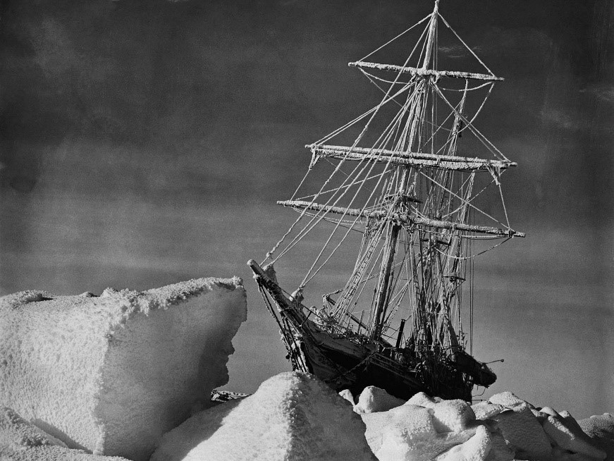 The ship, Nimrod behind ice floes.