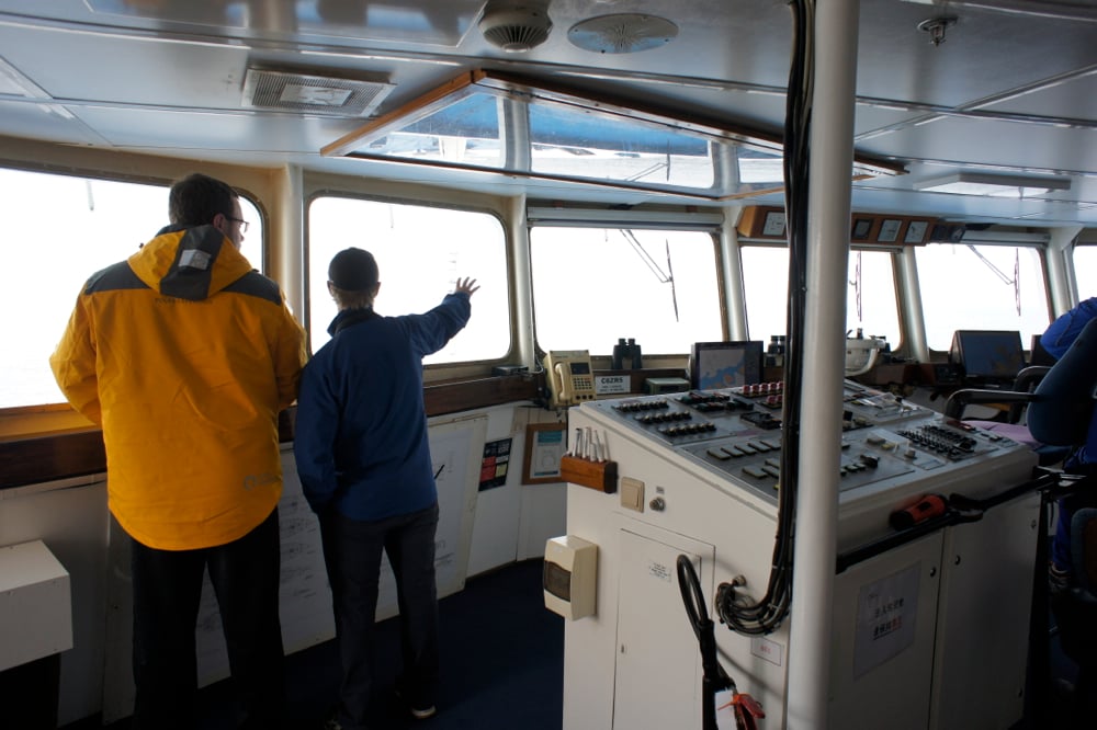 Naturalist and guide Jens Wikstrom explains the ice conditions ahead to a passenger onboard the Ocean Diamond.